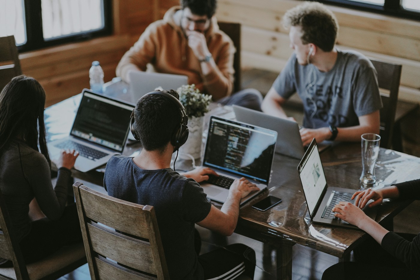 A team sharing ideas around a table in a bright workplace